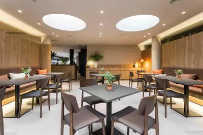 a restaurant with tables and chairs and lights at Hotel Terrassa Confort in Terrassa