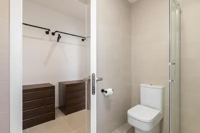 a bathroom with a toilet and a glass shower stall at Calella Apartments by Olala Homes in Calella