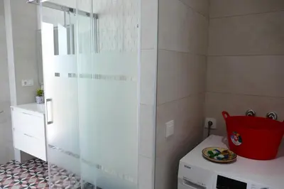 a bathroom with a glass shower and a plate on a counter at La LLar de la Kim, Bonita casa a 150m del mar y 40km de Barcelona in Arenys de Mar