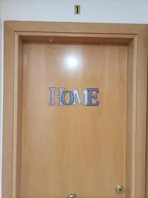 a home sign on the front of a door at SITGES WELCOM HOME a summer flat in the heart of the village Sitges in Sitges