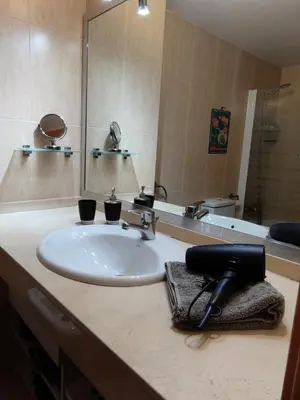 a bathroom counter with a sink and a mirror at SITGES WELCOM HOME a summer flat in the heart of the village Sitges in Sitges