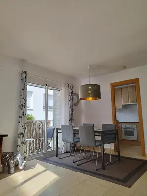 a kitchen and dining room with a table and chairs at SITGES WELCOM HOME a summer flat in the heart of the village Sitges in Sitges