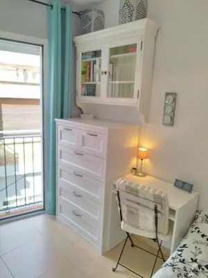 a bedroom with a white dresser and a desk at SITGES WELCOM HOME a summer flat in the heart of the village Sitges in Sitges