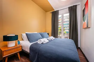a bedroom with a bed with towels on it at Sweett - Casa Miro in Barcelona