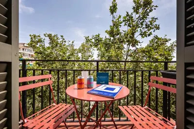 a table and two chairs on a balcony at Sweett - Casa Miro in Barcelona