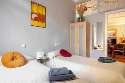 two beds sitting next to each other in a room at Luxury Central Apartment in Barcelona