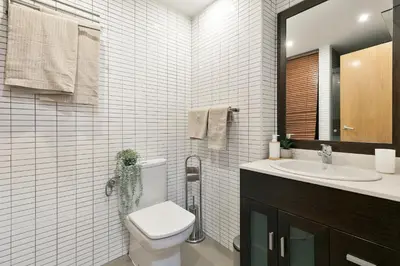 a bathroom with a toilet and a sink and a mirror at Click&Flat Sugranyes in Barcelona
