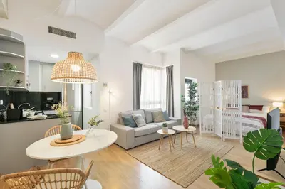 a living room with a couch and a table at Click&Flat Sugranyes in Barcelona