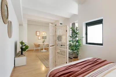 a bedroom with a bed and a desk in a room at Click&Flat Sugranyes in Barcelona