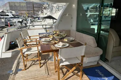 a wooden table and chairs on a boat at YACHT 20Metros in Barcelona
