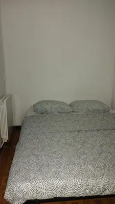 a bed in a bedroom with two pillows on it at Sant Adrià in Sant Adria de Besos