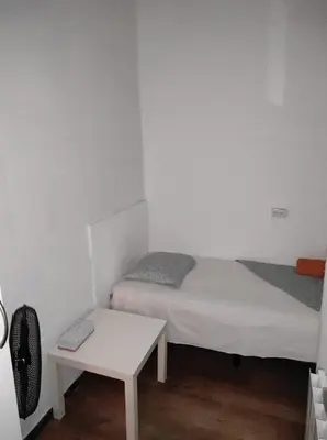 a small room with two beds and a table at Sant Adrià in Sant Adria de Besos