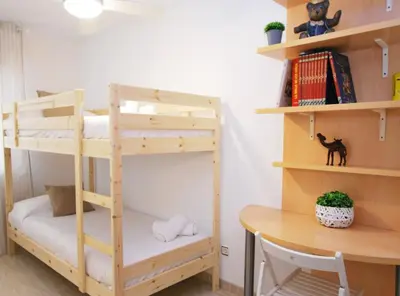 a bunk bed in a room with a desk at Gaudi Contemporani in Mataró