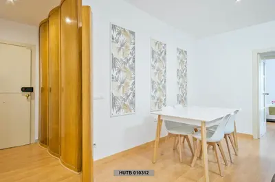 a dining room with a white table and chairs at Alcam Glorias in Barcelona
