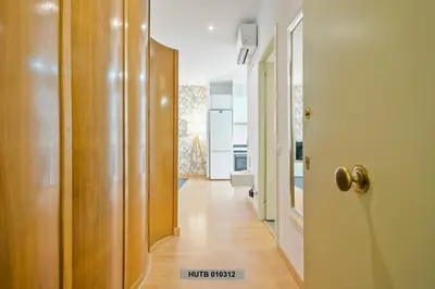 a hallway leading to a room with a door at Alcam Glorias in Barcelona