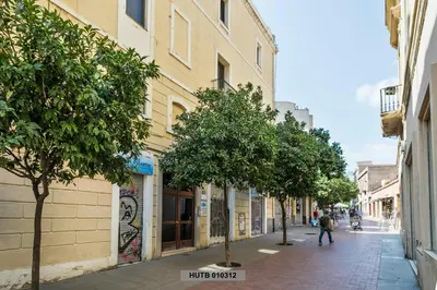 a street with trees on the side of a building at Alcam Glorias in Barcelona