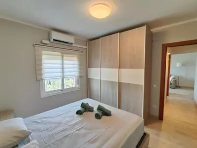 a bedroom with a bed with two green objects on it at Family apartment Besos in Sant Adria de Besos