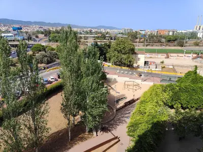 an overhead view of a park with trees and a street at Family apartment Besos in Sant Adria de Besos