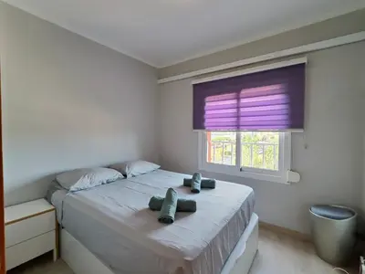 a bedroom with a large bed with a window at Family apartment Besos in Sant Adria de Besos
