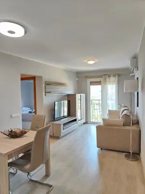 a living room with a table and a couch at Family apartment Besos in Sant Adria de Besos