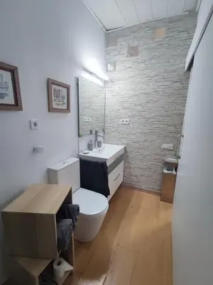 a bathroom with a white toilet and a sink at Apartamento a 10Km Barcelona, Jardin, Luminoso in Martorellas