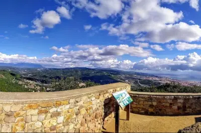 a stone wall with a view of a city at Wonderful house in the mountains with sea views in Cabrils