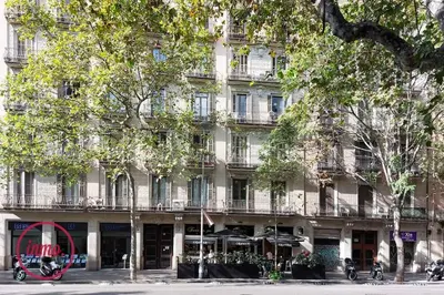 a large building with a red sign in front of it at Barcelona - Eixample 2 in Barcelona