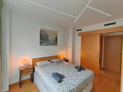 a bedroom with a bed with two pillows on it at Cozy apartment Forum beach in Sant Adria de Besos