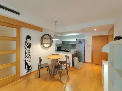 a kitchen and dining room with a table and chairs at Cozy apartment Forum beach in Sant Adria de Besos