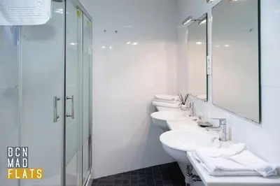a bathroom with three white sinks and a shower at Bcn - Sagrada Familia in Barcelona