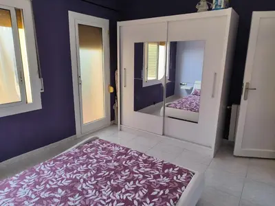 a room with a mirror and a purple wall at La casita de Pe Beach in Premiá de Mar