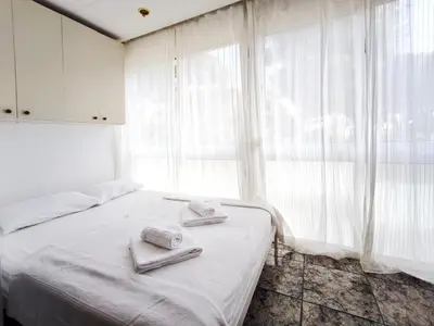 a bedroom with a bed with towels on it at Apartamento loft en Castelldefels junto la playa in Castelldefels
