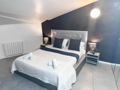 a bedroom with two beds with towels on them at Sitges Port View Apartment by Hello Homes Sitges in Sitges