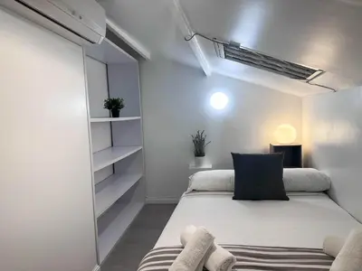 a small bedroom with a bed and a closet at Sitges Port View Apartment by Hello Homes Sitges in Sitges