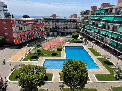 an apartment complex with a pool and a tennis court at Apartment Llavaneres near Barcelona Beach Pool in Sant Andreu de Llavaneres