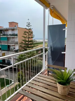 a balcony with a wooden bench and a view at Apartment Llavaneres near Barcelona Beach Pool in Sant Andreu de Llavaneres