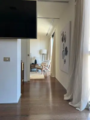 a living room with a flat screen tv on a wall at APARTMENT JUST 100mts FROM GAUDI'S CASA MILÀ-la Pedrera in Barcelona