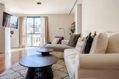 a living room with a white couch and a table at APARTMENT JUST 100mts FROM GAUDI'S CASA MILÀ-la Pedrera in Barcelona