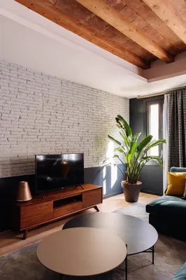 a living room with a tv and a couch and a table at Velvet in Rambla Cataluña in Barcelona
