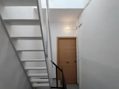 a staircase leading to a room with a door at Antic Manresa 2 in Manresa