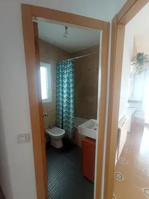 a bathroom with a toilet and a tub and a sink at Apartamento, 3° línea de playa in Cubelles