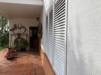 a hallway of a house with white doors and flowers at Casa Cal Duc, la Garriga in La Garriga