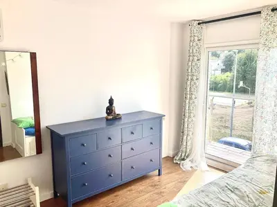 a blue dresser in a bedroom with a window at Alma Castellana, Casa en plena Naturaleza in Dosríus