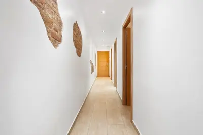 a hallway of a house with white walls at Space & Privacy Terrace, AC, Central Gràcia in Barcelona