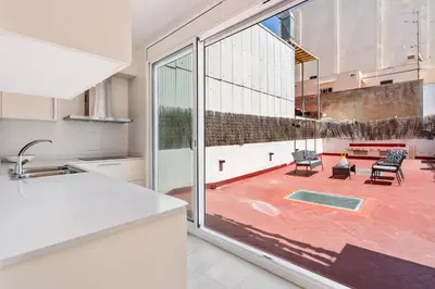 a kitchen with a large window and a patio at Space & Privacy Terrace, AC, Central Gràcia in Barcelona