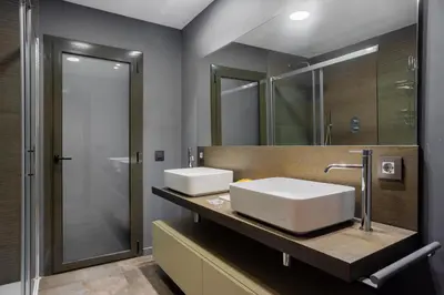 a bathroom with two sinks and a mirror at Sunny Beachside Haven 2 BD in the Marina District in Barcelona