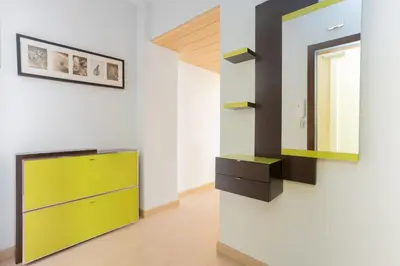 a room with a yellow cabinet and a mirror at Sunny Beachside Haven 2 BD in the Marina District in Barcelona