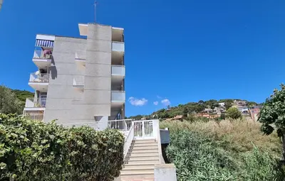 a stairway leading up to a building with a building at Hauzify I Apartaments Can Pi in San Pol de Mar