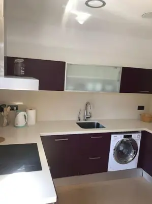 a kitchen with a sink and a washing machine at Villa Barcelona en Olivella in Olivella