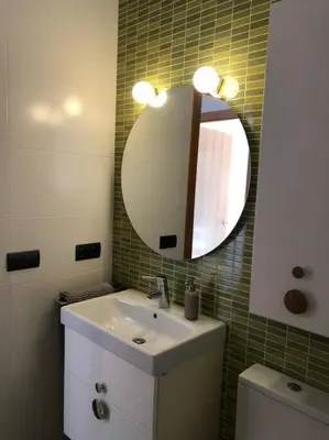 a bathroom with a sink and a mirror and a toilet at Villa Barcelona en Olivella in Olivella